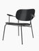 A Co Lounge Chair with a black upholstered seat, black-painted oak backrest, and a slender black powder-coated steel frame.