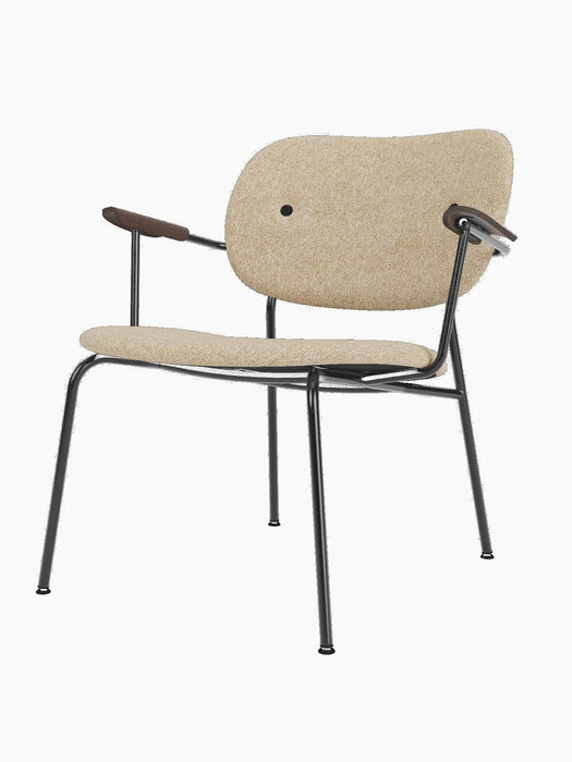 Co Lounge Chair, fully upholstered in light brown Moss fabric, with dark stained oak armrests and a black metal frame.