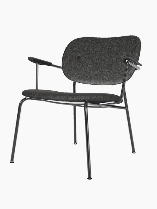 Side view of the Co Lounge Chair, fully upholstered in dark grey Re-wool with black painted oak armrests and a black frame.