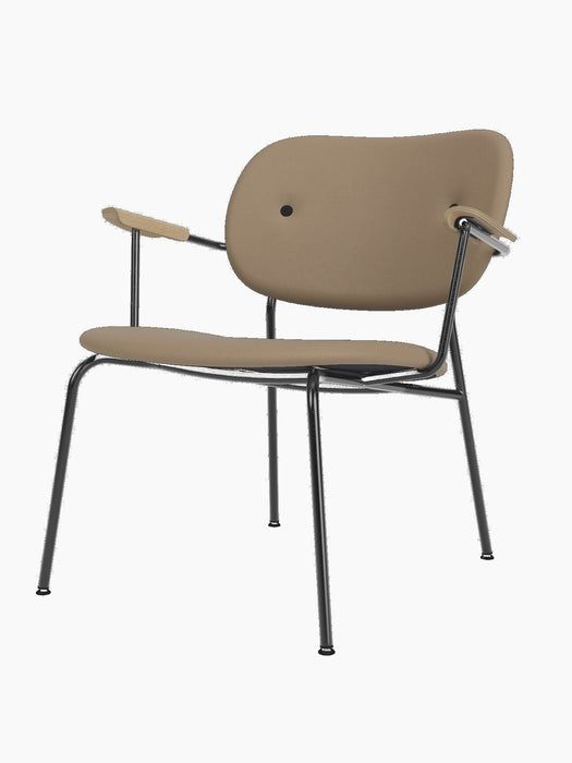 A Co Lounge Chair, fully upholstered in stone-coloured Sierra leather, with natural oak armrests and a black steel frame.