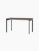 An angled view of the Co Table, featuring a rectangular terra laminate top, solid oak trim, and slender black steel legs.