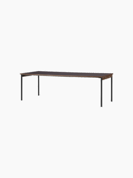 Rectangular Co Table with Terra Laminate top, oak trim, and black steel legs, shown at an angle against a black background.
