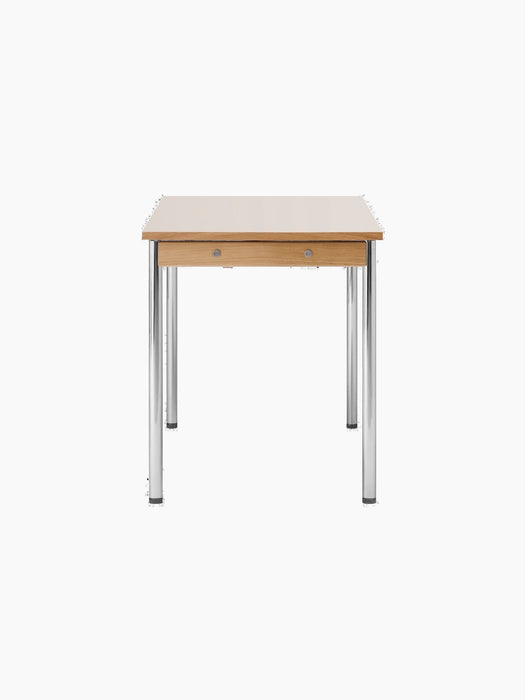 Side view of the Co Table, showing its creme laminate top, solid oak apron with decorative screws, and chromed legs.