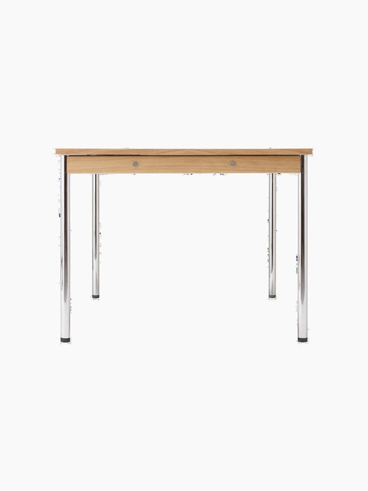 Side view of the rectangular Co Table with a creme laminate top, oak apron with decorative screws, and four slim chrome legs.