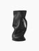 The black Collapse Vase, with a sculptural, organic silhouette. Its surface features soft, undulating folds.