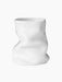 Front view of the white Collapse Vase 20, a sculptural ceramic vase with an organic, crumpled shape, on a black background.
