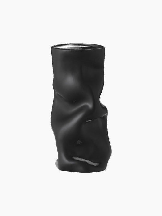 A front-on shot of the black Collapse Vase. The modern, sculptural vase has a matte finish and distinctive crumpled form.