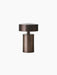 The portable Column Table Lamp in a bronzed aluminium finish. The mushroom-shaped lamp is shown against a black background.