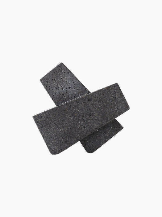 Converge Book Ends, two dark grey rectangular blocks with a porous, stone-like texture, crossed over each other.