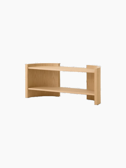 Angle view of the Passage Lounge Table in natural oak, showcasing its two curved shelves and minimalist design.