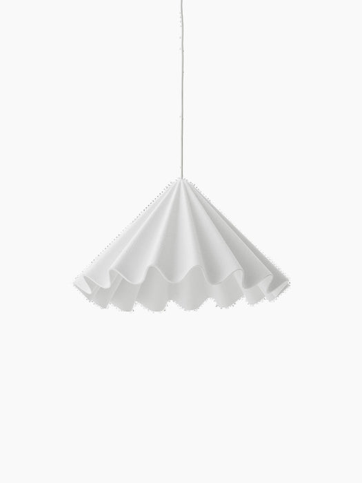 The white Dancing Pendant Lamp with a flared, pleated felt shade resembling a dancer's skirt, against a black background.