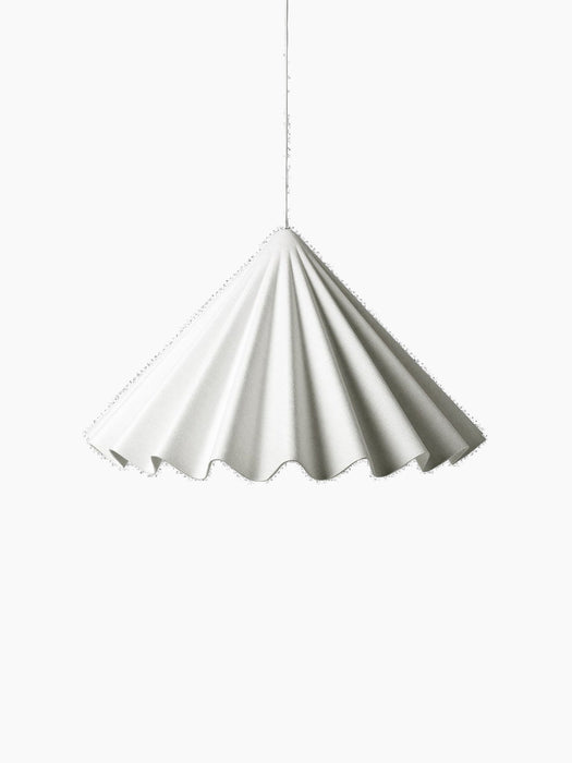 A white Dancing Pendant Lamp hangs against a black background. The shade is pleated felt and has a wavy edge like a skirt.