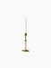 The tall, slender Duca Candle Holder in olive green with a rattan handle, holding a white candle on a black background.