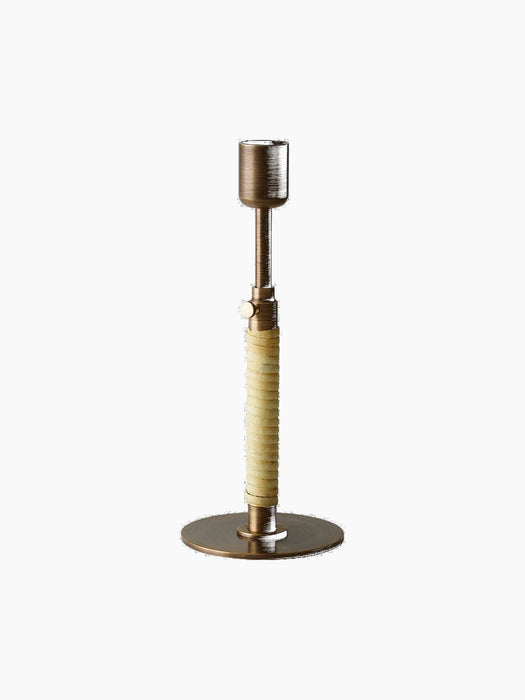 Duca Candleholder in Bronzed Brass, featuring an adjustable stem wrapped in natural rattan, against a black background.