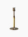 Duca Candleholder in Bronzed Brass, featuring an adjustable stem wrapped in natural rattan, against a black background.