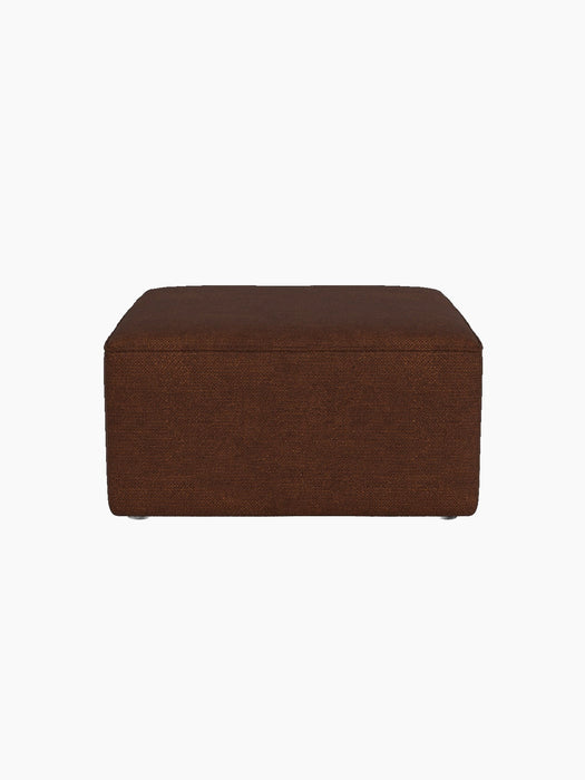 A side view of the Eave Modular Pouf, 75, upholstered in a textured brown Audo Bouclé 08 fabric against a black background.