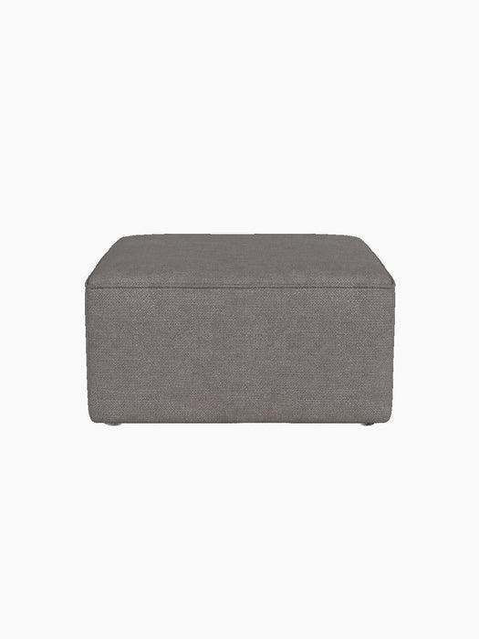 Front view of the square Eave Modular Pouf, 75, showing its piped seam. It is upholstered in grey Audo Bouclé 16 fabric.