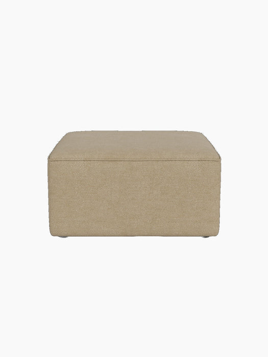 Front view of the Eave Modular Pouf, 75. The square pouf is upholstered in a textured, light beige Audo Bouclé 02 fabric.
