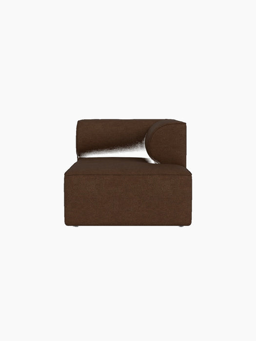 Front view of Eave Modular Sofa Chaise Longue module upholstered in brown Audo Bouclé 07 fabric against a black background.