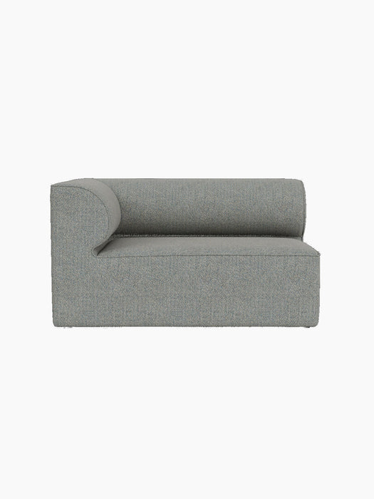 A front-on view of the Eave Modular Sofa, 86, Corner 129 in a light grey and blue textured fabric against a black background.