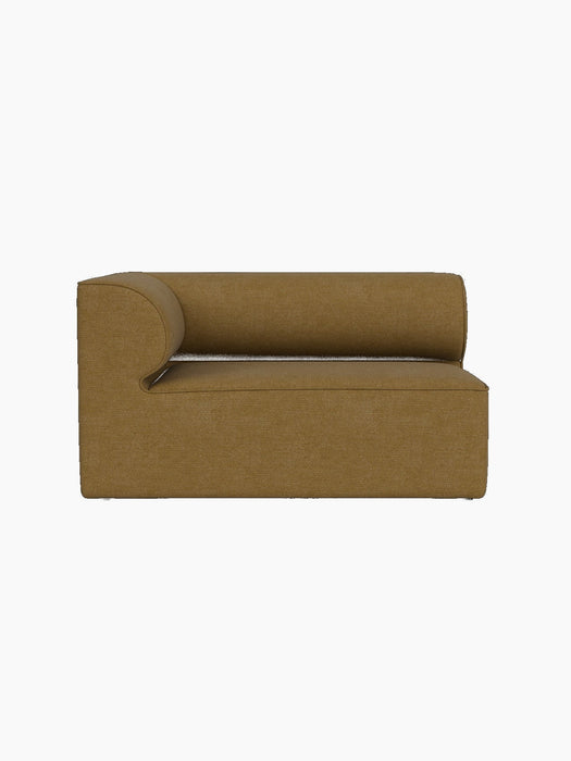 A front-on view of the Eave Modular Sofa, 86, Corner 129 module, upholstered in a textured, brownish-yellow Bouclé fabric.