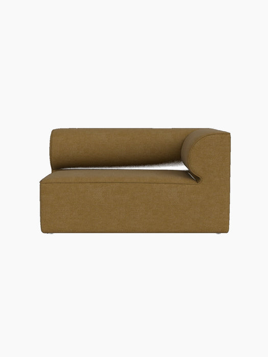 Front view of the Eave Modular Sofa, 86, Corner 129 module in ochre Audo Bouclé 06 fabric, against a black background.