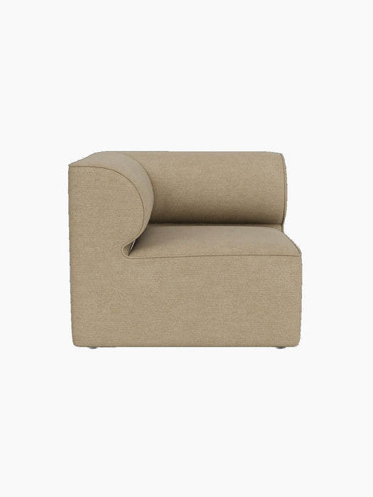Side profile of the Eave Modular Sofa 86 Corner piece in light beige Audo Bouclé 02 fabric against a black background.