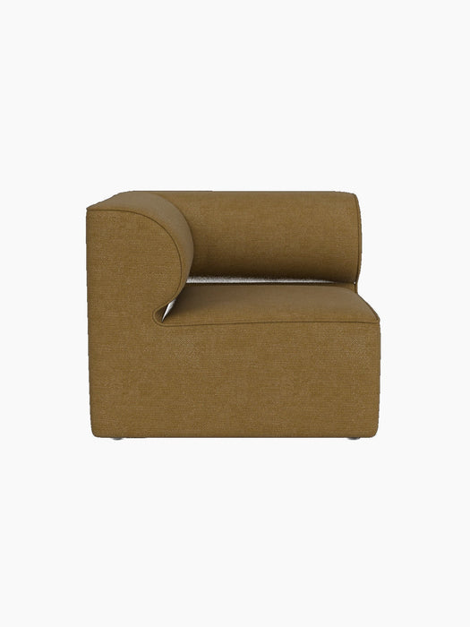 Side view of the Eave Modular Sofa 86 Corner in textured, brownish-yellow Audo Bouclé 06 fabric against a black background.