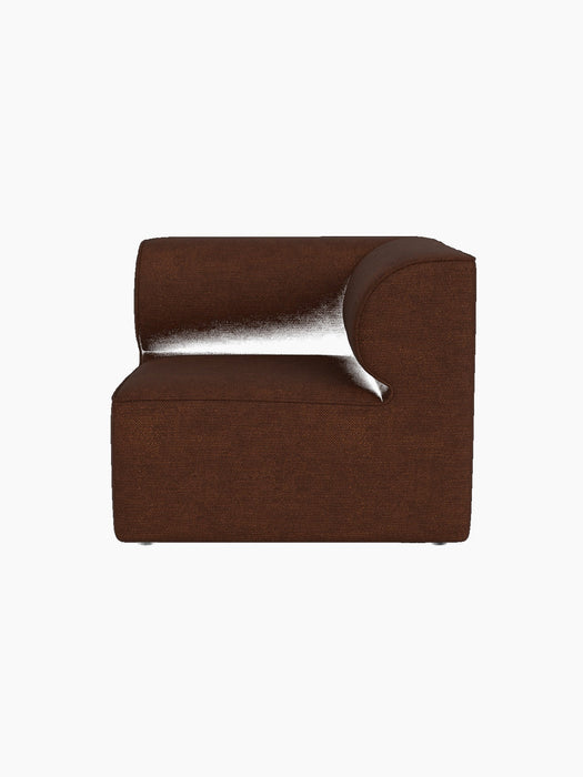 A front view of the Eave Modular Sofa, 86, Corner in a reddish-brown Audo Bouclé 08 fabric, isolated on a black background.