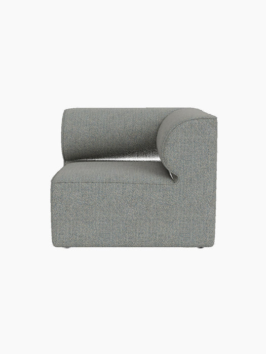 A front view of the Eave Modular Sofa, 86, Corner module, upholstered in a textured grey-blue fabric on a black background.