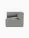A front view of the Eave Modular Sofa, 86, Corner module, upholstered in a textured grey-blue fabric on a black background.
