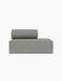 A side view of the Eave Modular Sofa, 86, Open End module in a light grey textured upholstery against a black background.