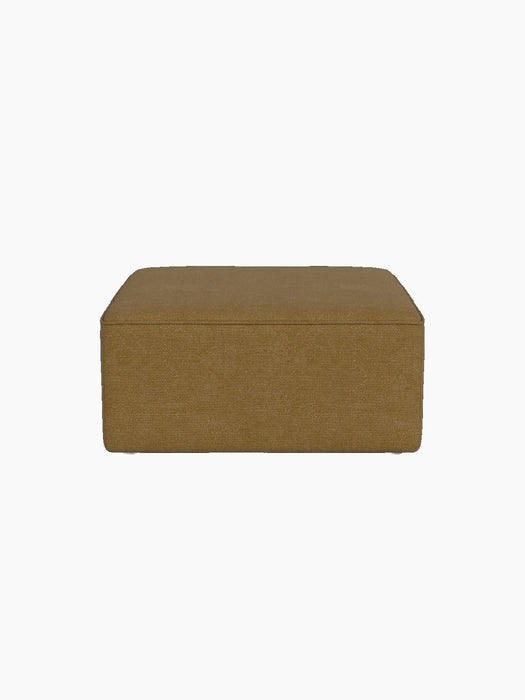 A square Eave Modular Sofa 86 Pouf in a textured, mustard yellow Audo Bouclé 06 fabric, seen front-on on a black background.