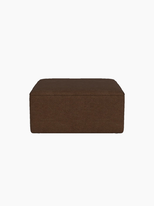 A side view of the square Eave Modular Sofa 86 Pouf, upholstered in a textured, brown Audo Bouclé 07 fabric.