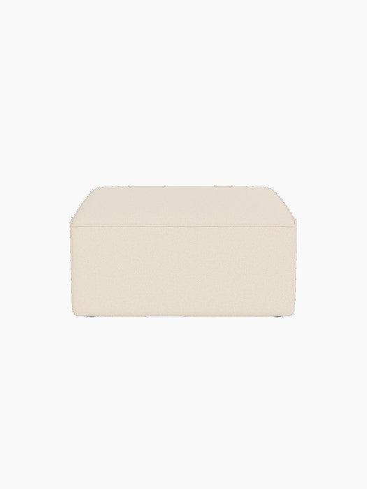 The Eave Modular Sofa Pouf, 86cm, shown from the front. It is upholstered in a textured, off-white Logan Jasmine fabric.