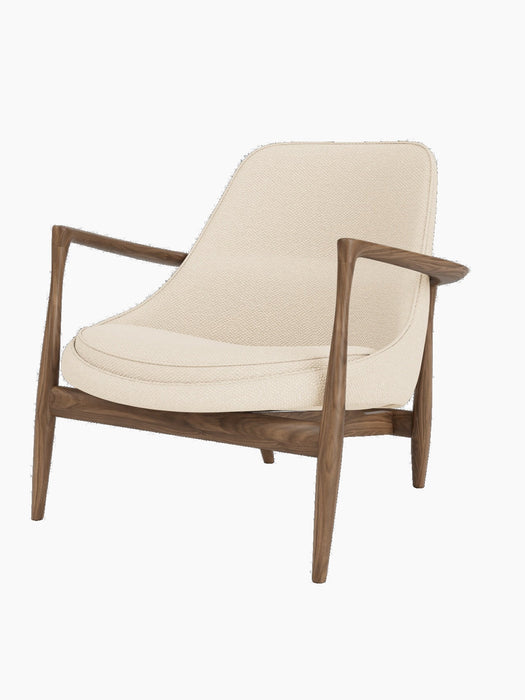 A three-quarter view of the Elizabeth Lounge Chair with walnut frame, sculpted armrests and Logan Jasmine upholstery.