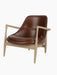 A three-quarter view of the Elizabeth Lounge Chair with a natural oak frame, sculpted arms and brown leather upholstery.