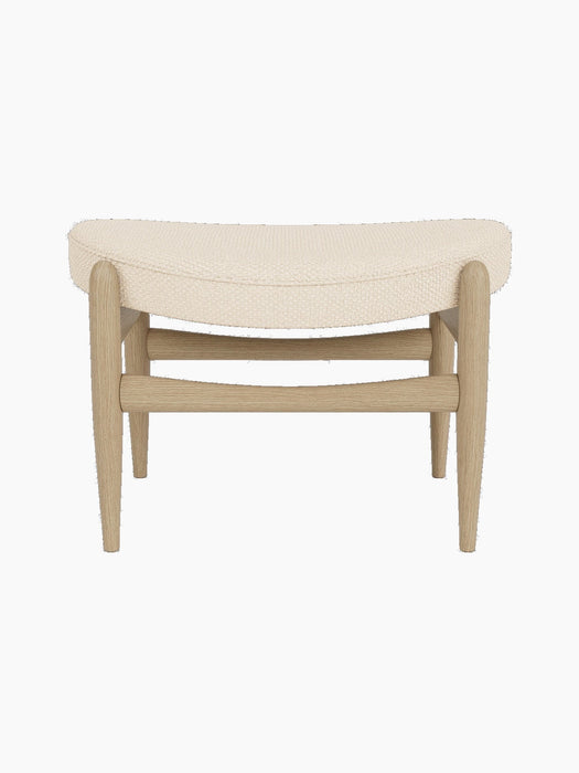Front view of the Elizabeth Ottoman with natural oak frame and a curved cushion upholstered in Logan Jasmine fabric.