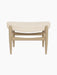 Front view of the Elizabeth Ottoman with natural oak frame and a curved cushion upholstered in Logan Jasmine fabric.