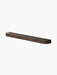 The Audo Échasse Tray, a long, minimalist tray in dark smoked oak with a glass base, shown at an angle.