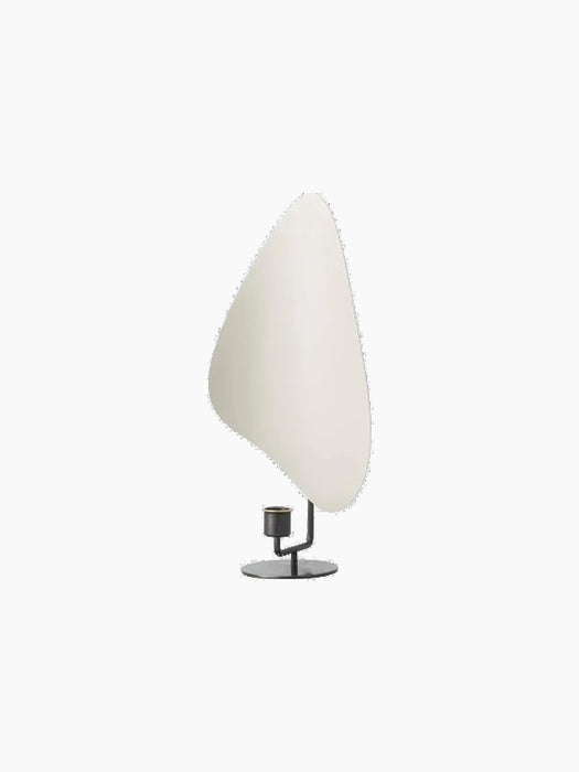 Angled view of the Flameau Candle Holder in bronzed brass and grey, featuring a sculptural base and large, white reflector.