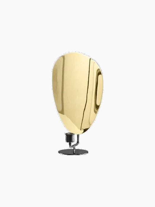 Angled view of the Flambeau Candle Holder H30, with its black base and polished brass plate that reflects candlelight.
