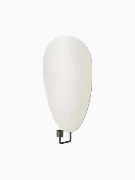 Angled view of the Flambeau Wall Candle Holder, featuring a teardrop-shaped grey reflector and a bronzed brass candle cup.