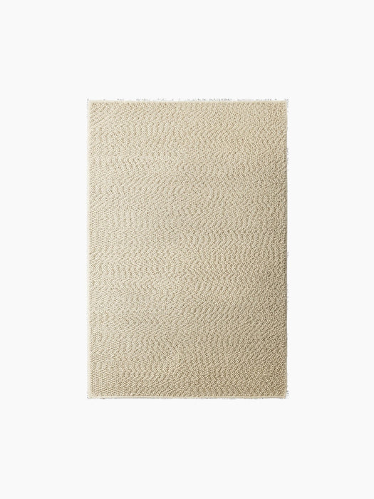 A top-down swatch of the Gravel Rug in Ivory, showing its textured weave, isolated on a black background