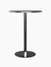 A studio photograph of the Harbour Column Bar Table, featuring a round top in charcoal linoleum on a black column and base.