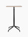 Front view of the Harbour Column Bar Table, featuring a rectangular Kunis Brescia stone top and a sleek black star base.