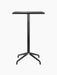 Front view of the black Harbour Column Bar Table with a rectangular charcoal linoleum top and a slender star-shaped base.