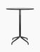A front view of the Harbour Column Bar Table, featuring a round black oak top and a black column with a star-shaped base.