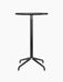 Front view of the Harbour Column Bar Table. The table features a round charcoal linoleum top and a slender black star base.
