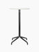 Front view of the Harbour Column Bar Table, featuring a round Estremoz marble top and slender black column with a star base.